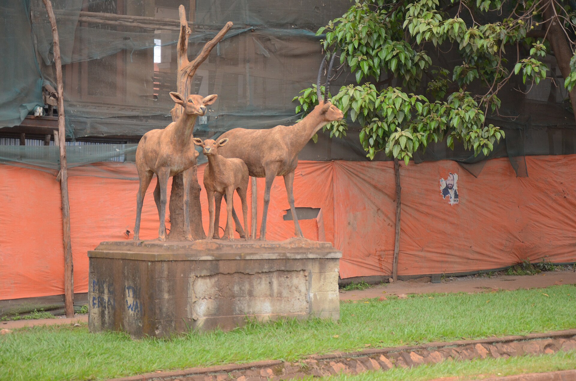 A roadside sculpture of antelopes on a plinth in Mengo, representing the Engabi clan of Buganda.