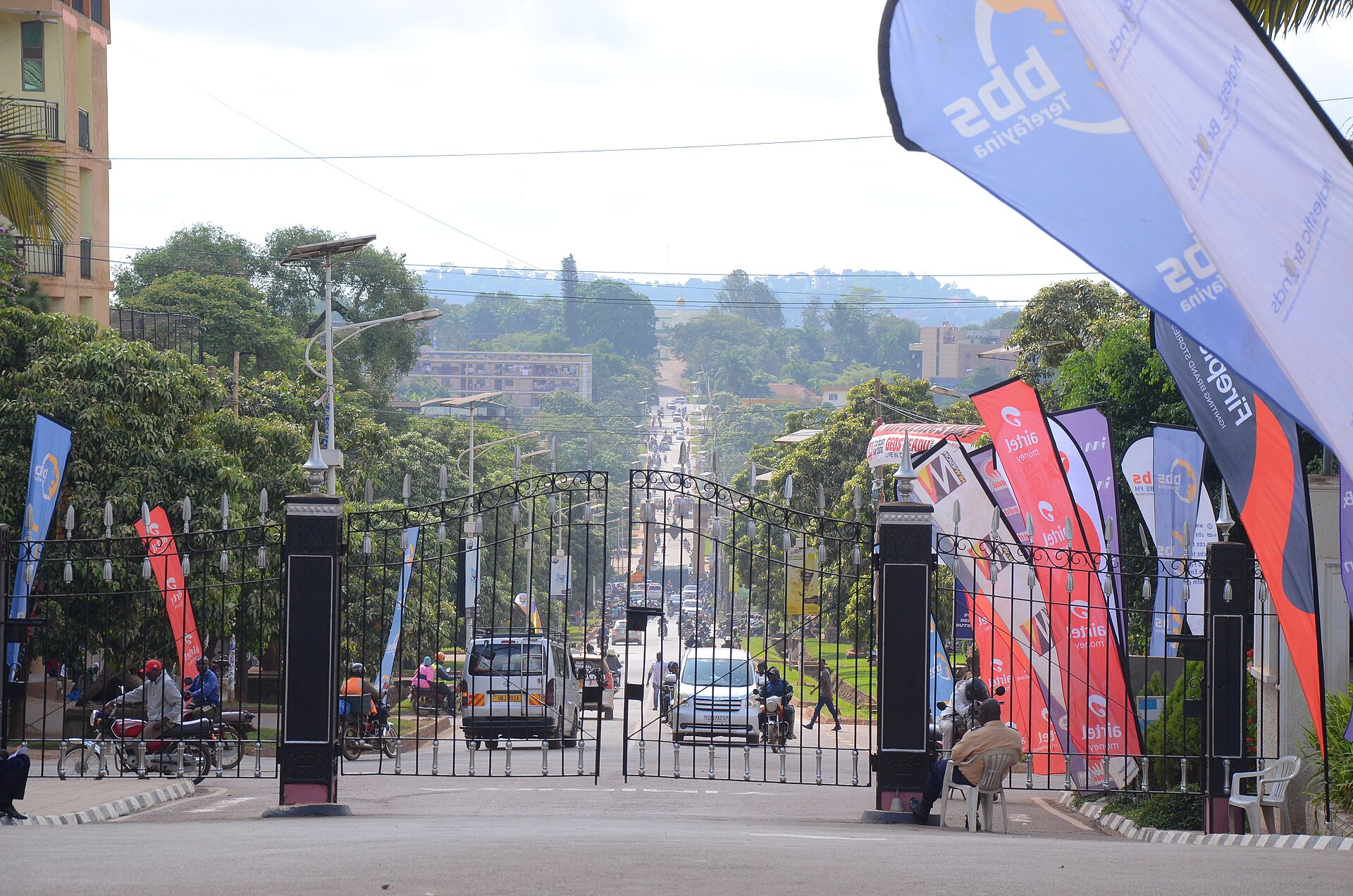 The Royal Mile in Mengo, a straight ceremonial avenue of trees and traffic running toward the palace gates.
